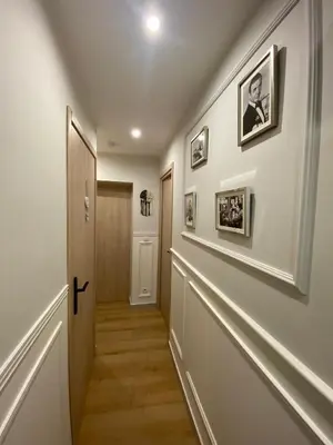 a hallway of a home with white walls and wood floors at Appartement rénové Cannes Suquet in Cannes