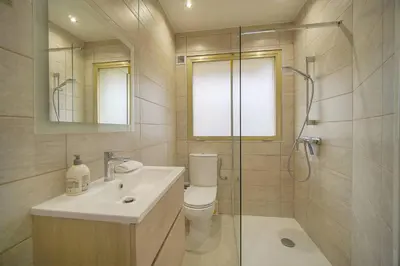 a bathroom with a toilet and a sink and a shower at FRGK 