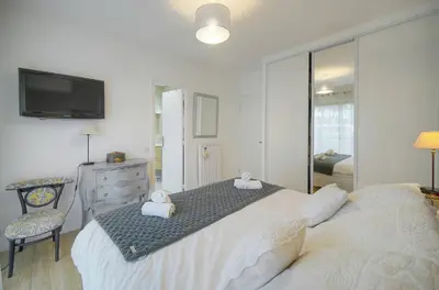a bedroom with a large bed with a tv on the wall at FRGK 