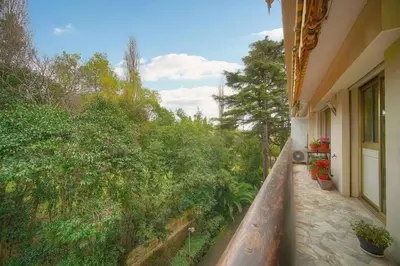 a balcony of a house with trees and plants at FRGK 