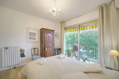 a bedroom with a large bed and a balcony at FRGK 