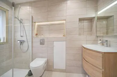 a bathroom with a shower and a toilet and a sink at FRGK 