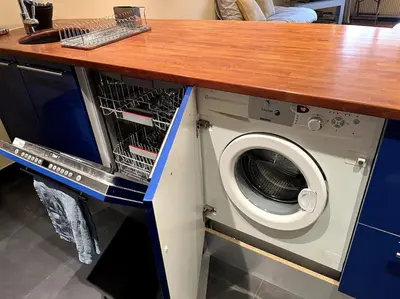 a kitchen with a washing machine under a counter at Cannes Montfleury grand confort in Cannes