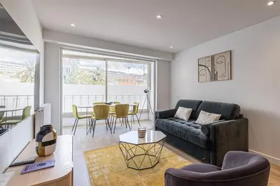 a living room with a couch and a table at Magnificent 3room apartment quiet balcony in Cannes