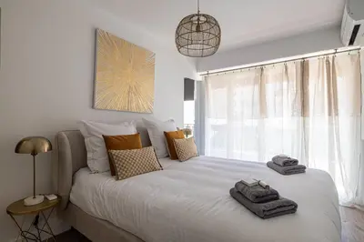 a bedroom with a white bed with towels on it at Magnificent 3room apartment quiet balcony in Cannes