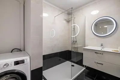 a bathroom with a washing machine and a sink at Magnificent 3room apartment quiet balcony in Cannes