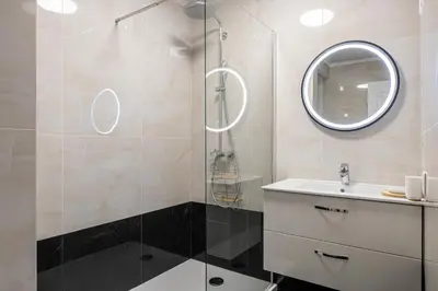 a bathroom with a shower and a sink and a mirror at Magnificent 3room apartment quiet balcony in Cannes