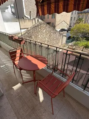 two chairs and a table on a balcony at Magnificent 3room apartment quiet balcony in Cannes