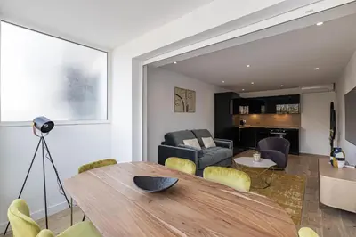 a dining room and living room with a table and chairs at Magnificent 3room apartment quiet balcony in Cannes