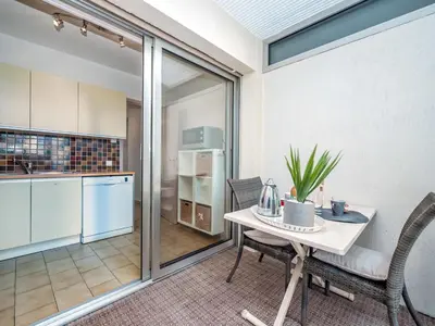 a kitchen and dining room with a table and chairs at Apartment Les Sablons-2 by Interhome in Cannes