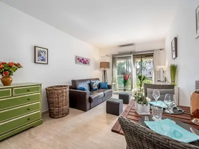 a living room with a couch and a table at Apartment Les Sablons-2 by Interhome in Cannes