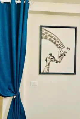 a picture of a giraffe on a wall with a blue curtain at Luxury&Privacy - Pool, Parking, AC - Palais in 5' in Cannes