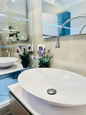 a white sink in a bathroom with purple flowers at Luxury&Privacy - Pool, Parking, AC - Palais in 5' in Cannes