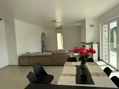 a living room with a table and a couch at Villa Paradis - Cannes in Cannes