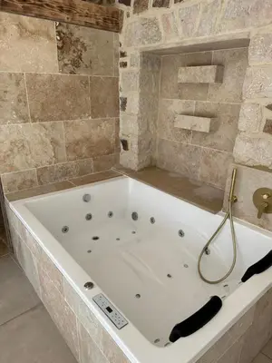 a large white bath tub in a bathroom at Villa Paradis - Cannes in Cannes