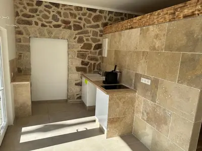a kitchen with a stone wall and a counter at Villa Paradis - Cannes in Cannes