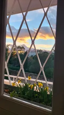 a window with a view of a sunset at Le Vallombrosa - Deux pièces lumineux et confortable in Cannes