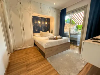 a bedroom with a bed and a large window at Piscine privée, Plages à pied & Palais à proximité in Cannes