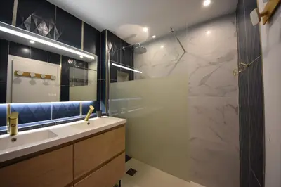 a bathroom with a sink and a glass shower at Piscine privée, Plages à pied & Palais à proximité in Cannes