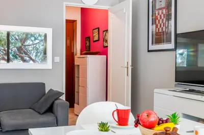 a living room with a couch and a table at 2-Room Apartment with Terrace Sea View in Cannes