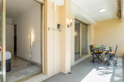a room with a table and a dining room at 2-Room Apartment with Terrace Sea View in Cannes