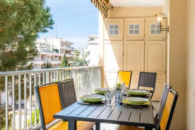 a table on a balcony with a table and chairs at 2-Room Apartment with Terrace Sea View in Cannes