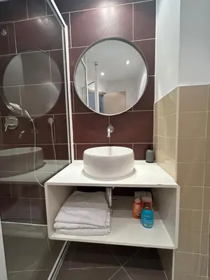 a bathroom with a sink and a mirror at Charmant studio centre ville Cannes in Cannes