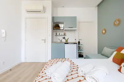 a bedroom with a white bed with towels on it at Confortable studio Cannes centre in Cannes