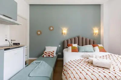 a bedroom with two beds and a sink in it at Confortable studio Cannes centre in Cannes