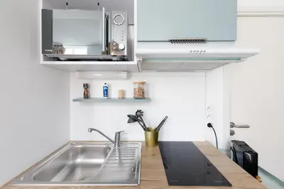 a kitchen with a sink and a microwave at Confortable studio Cannes centre in Cannes