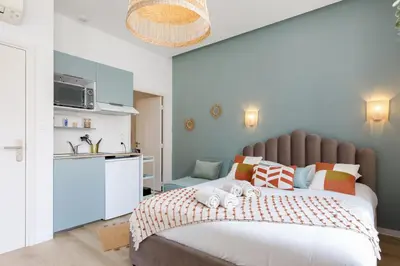 a bedroom with a large bed with towels on it at Confortable studio Cannes centre in Cannes