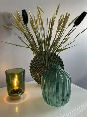 a green vase and a candle on a table at Appartement Les Eucalyptus dans domaine privé à Cannes in Cannes