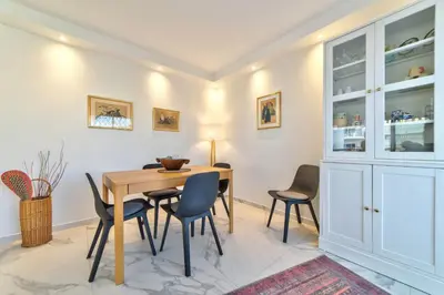 a dining room with a table and chairs at Appartement Reina Pointe Croisette Palm Beach in Cannes