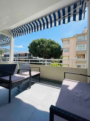 a balcony with chairs and a pergola on a building at L'Orangeraie Centre Cannes Martinez, Beau F2 avec terrasse in Cannes