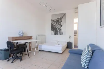 a living room with a blue couch and a table at Carnot Prestige – Spacious & Central in Cannes