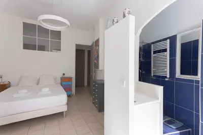 a bedroom with a bed and a blue wall at Carnot Prestige – Spacious & Central in Cannes