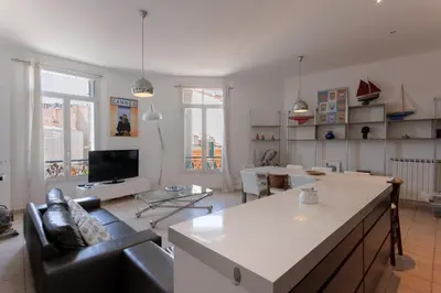 a living room with a couch and a table at Carnot Prestige – Spacious & Central in Cannes
