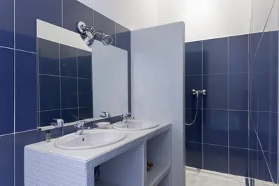 a bathroom with two sinks and a mirror at Carnot Prestige – Spacious & Central in Cannes