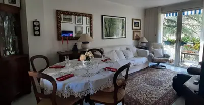 a living room with a table and a white couch at Holiday or Congress, Centre - Beach in Cannes