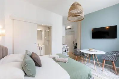 a living room with a couch and a table at Comfortable studio W balcony Cannes center TGV in Cannes