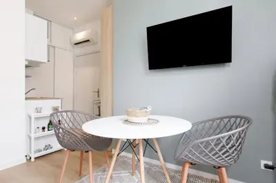 a dining room with a white table and two chairs at Comfortable studio W balcony Cannes center TGV in Cannes
