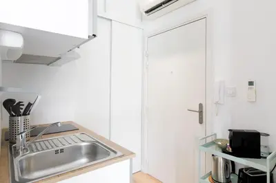 a kitchen with a stainless steel sink and a counter at Comfortable studio W balcony Cannes center TGV in Cannes