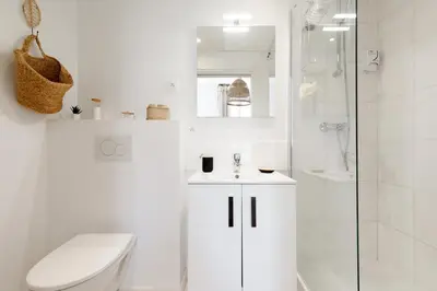 a white bathroom with a toilet and a shower at Comfortable studio W balcony Cannes center TGV in Cannes