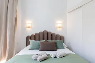 a bedroom with a bed with two towels on it at Comfortable studio W balcony Cannes center TGV in Cannes