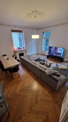 a large couch in a living room with a table at Appartement Bourgeois Cannes Palais in Cannes