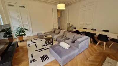 a bedroom with a bed and a wooden floor at Appartement Bourgeois Cannes Palais in Cannes