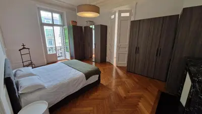 a kitchen with a table in the middle of it at Appartement Bourgeois Cannes Palais in Cannes