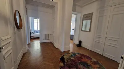 a living room with a couch and a table at Appartement Bourgeois Cannes Palais in Cannes