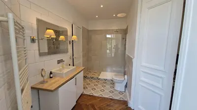 a bedroom with a bed and a window and a television at Appartement Bourgeois Cannes Palais in Cannes