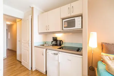 a small kitchen with a sink and a microwave at Résidence La Palme d'Azur Cannes Verrerie in Cannes